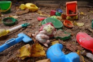 1979397-forgotten-toys-in-a-dirty-sandbox-depressive-mood
